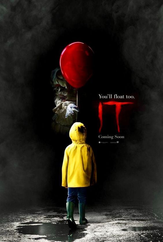 IT 2017 movie poster. Features a small child in a yellow raincoat, being handed a red balloon from someone in the shadows