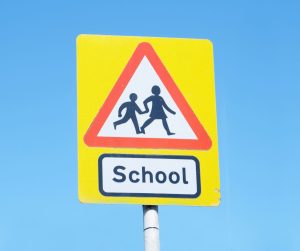 School children crossing road sign