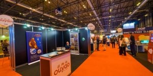 exhibition stand in a large exhibition hall with red carpet