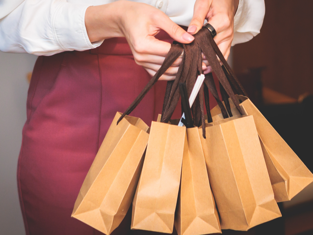 Person holding multiple gift bags