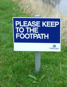 Please keep to the footpath sign on grass