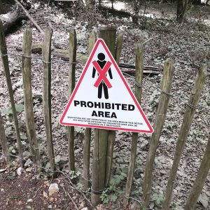 Pedestrians prohibited sign in a woodland area