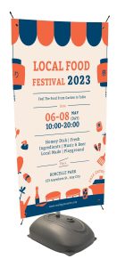 An outdoor banner stand advertising a local food festival in 2023.