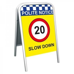 pavement sign with 'polite notice 20mph slow down'